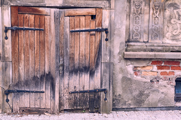 Old gate made of wood  with steel hinges in Gdansk, Poland