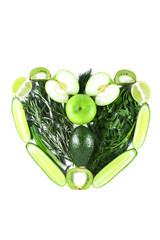 Heart shape made from green fruits and vegetables. Heart made from natural products on a white background. Isolated vegetarian heart