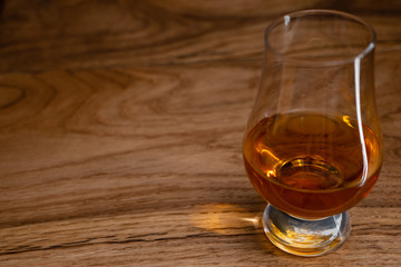 Irish Whiskey in Glencairn Glass on Wooden Background