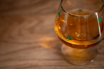 Shamrock Irish Whiskey Glass on Wooden Background OverHead