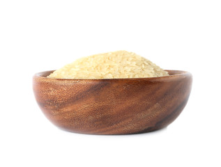 Bowl with uncooked parboiled rice on white background
