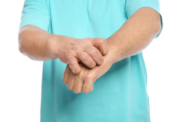 Mature man scratching hand on white background, closeup. Annoying itch