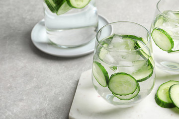 Glasses with fresh cucumber water served on table