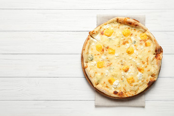 Hot cheese pizza Margherita on white wooden background, top view. Space for text
