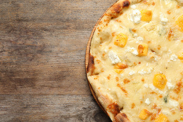 Hot cheese pizza Margherita on wooden background, top view. Space for text