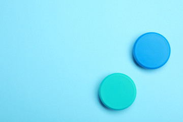 Bright magnets on color background, top view with space for text