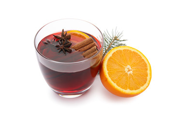 Glass of mulled wine with fir branch and orange isolated on white