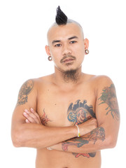 portrait of unfriendly asian punk guy with mohawk hair style, piercing and tattoo isolated on a white background - obrazy, fototapety, plakaty