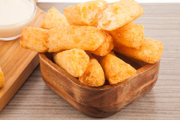 Fried cassava in wood background