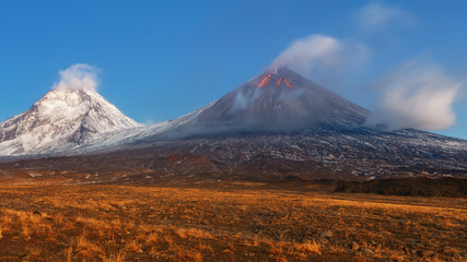 Autumn mountain landscape view at sunrise of eruption active volcano