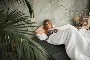 young beautiful woman wakes up in bed
