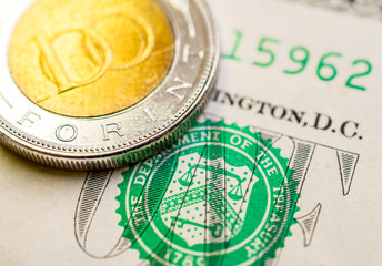 Hungarian forint US dollar exchange rate: Hungarian 100 forint coin placed on 1 dollar bill