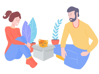 Young couple welcomes a new member of the family. A fluffy cat looks out of the box.