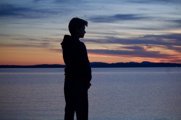 silhouette of boy at sunset