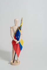 Venezuelan flag held by man made in wood on white background ideal for political and social...