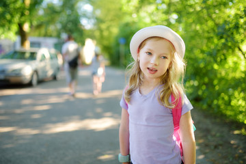 Cute preteen girl sightseeing on the streets of Vilnius on warm and sunny summer day