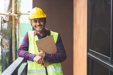 Home inspection consultancy. Asian inspector in site construction.