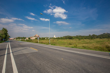 Fototapeta premium The background of the grass on the roadside and the bright blue sky, is a refreshing atmosphere of good weather.