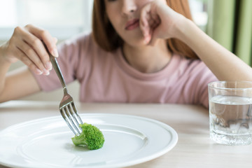 Woman on dieting. Depressed teen looking at her empty plate dinner. - obrazy, fototapety, plakaty