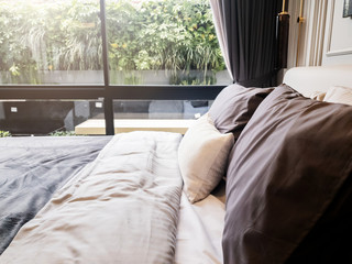 Bed maid-up with clean white pillows and bed sheets in beauty bedroom. Close-up. interior background