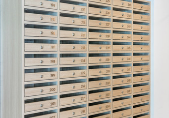 Mail boxes filled of leaflets and letters, Mailboxes and Lock in Rows at Entrance.
