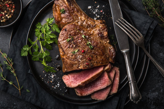 sliced beef steak on black plate