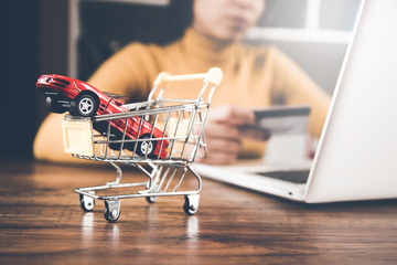 car model on basket with woman hand card