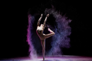 Majestic dancing woman in colorful flying powder