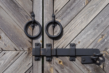 Two rings and bolt on old wooden gate