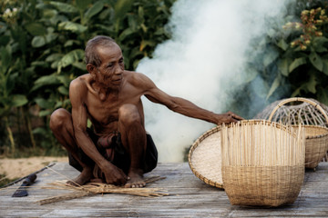 Old man and wooden basket.
