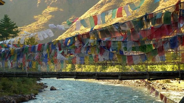 Suspension bridge covered in prayer flags near Paro, Bhutan