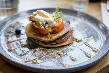 Sweet matcha pancakes with syrup and grilled nectarines