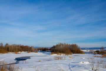 Winter landscape. Forest, river, snow. Sunny day.