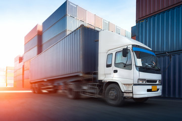 Truck on road motion blur in shipping yard or dock yard at sunset