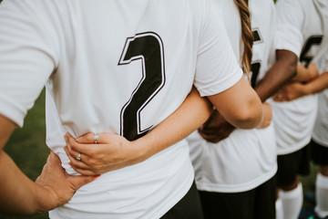 Close up of female football players huddling