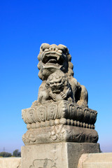 Fototapeta na wymiar stone lion on bridge railing, China