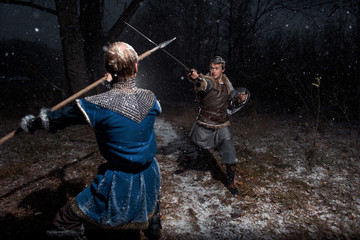 The battle between medieval knights in the style of Game of Thrones in winter forest landscapes....