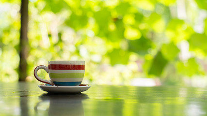 cup of tea on wooden table in garden