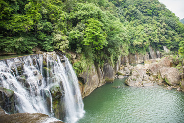 Fototapeta na wymiar Shifen Waterfall is a scenic waterfall located in Pingxi District, New Taipei City, Taiwan, on the upper reaches of the Keelung River.