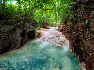 Naklejka premium River in a mountain gorge in the tropical jungle of the Philippines.