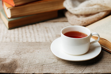 Valentines day concept with tea cup and books on wooden vintage background, cozy weekend, hygge leisure concept