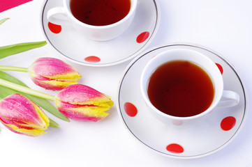Tea for Two. Two cups of tea and a bouquet of tulips. Table service on Valentine's day.