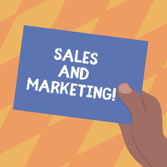Text sign showing Sales And Marketing. Conceptual photo activities for selling and advertising products Drawn Hu analysis Hand Holding Presenting Blank Color Paper Cardboard photo