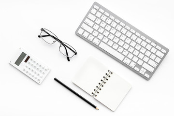 Office desk in order. Geometry. Computer keyboard and office supplies, glasses on white background top view copy space