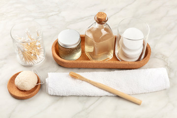 Sustainable toiletries. Homemade lotions, cotton pads, bamboo toothbrush, natural Konjac sponge, and biodegradable bamboo cotton swabs
