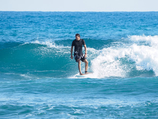 Surfer on blue Atlantic Ocean wave. Tropical winter.  Shortboard.