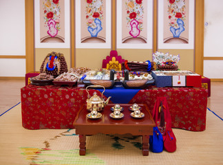 Bride holds a wedding bouquet. Very nice young woman in a white wedding dress holding a beautiful blossoming flower bouquet of various kinds of fresh real flowers, in pink, red and pastel cream color.