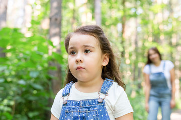 Family and nature concept - Close up portrait of offended child girl in the park