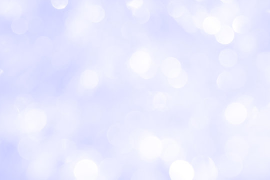 A brilliant blurry background of blue. Template for a holiday greeting card and labels with a pattern of circles with neon glitter.