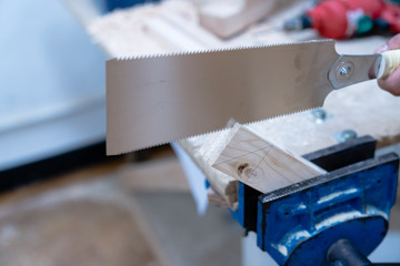 Technician handles a variety of woodworking tools to make wooden products. Both hand and machine tools are used after carpenters measure exact size by different types of rulers.